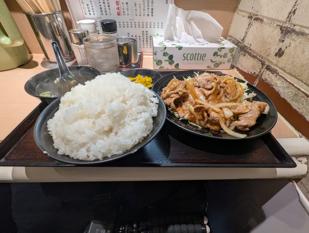 A set of pork ginger and a large portion of rice.